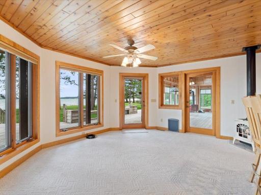 The dining area enjoys beautiful lake views and seamless access to both the lakeside deck and vaulted three-season porch.
