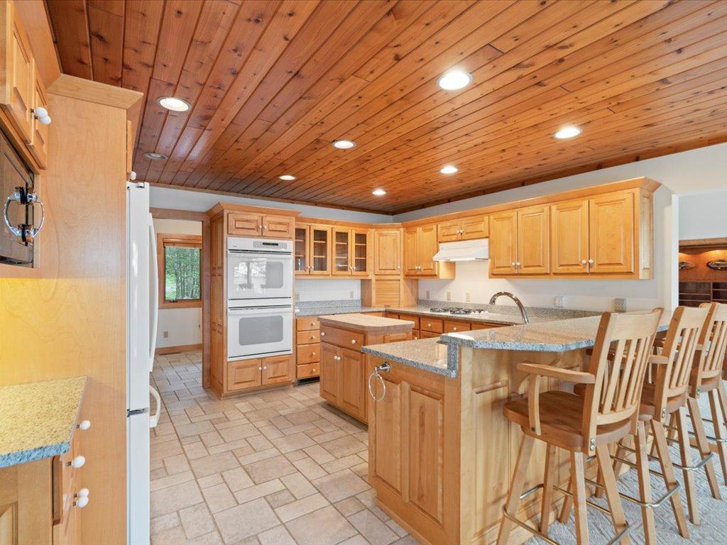 Designed for gathering, the spacious kitchen features expansive workspace, casual seating, and a seamless connection to the home's main living areas.