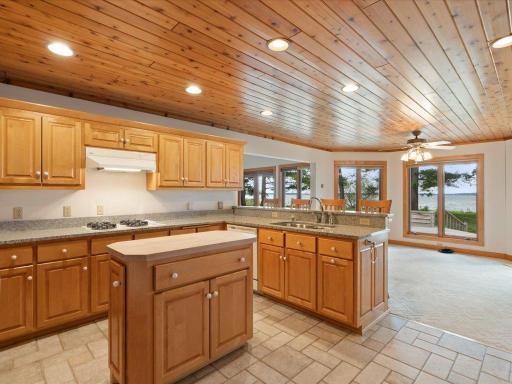 The spacious kitchen is thoughtfully positioned to serve the main gathering areas while enjoying views of Upper Whitefish Lake.