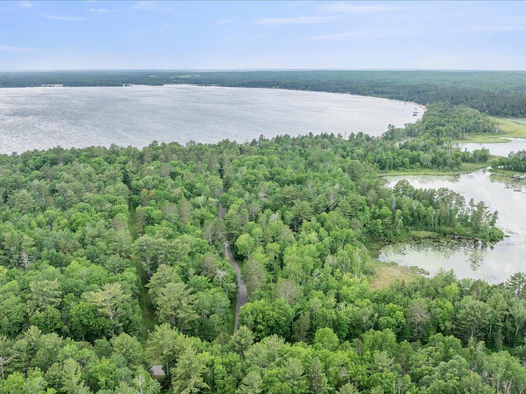 Few properties offer this combination of acreage, shoreline, and access to multiple lakes within the Whitefish Chain.