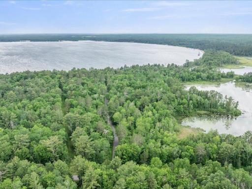Few properties offer this combination of acreage, shoreline, and access to multiple lakes within the Whitefish Chain.