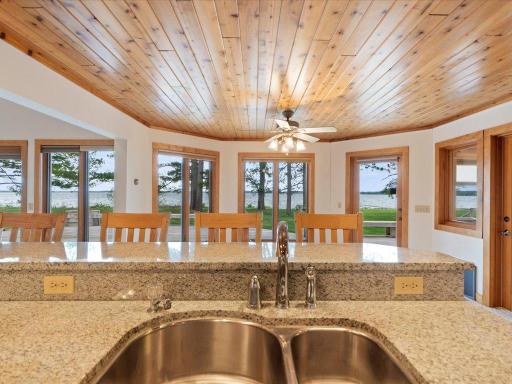 Enjoy sweeping views of Upper Whitefish Lake from the heart of the home, where the kitchen, dining area, and waterfront setting come together beautifully.
