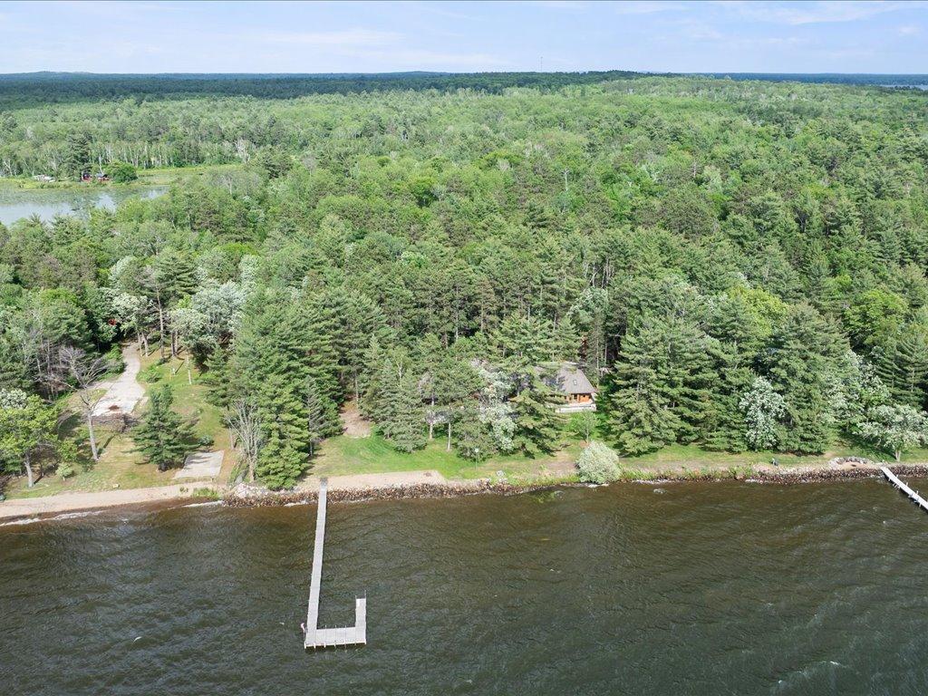 A rare opportunity to own 21.4 acres of private Whitefish Chain shoreline, where towering pines and expansive waterfront create an unmatched estate setting.