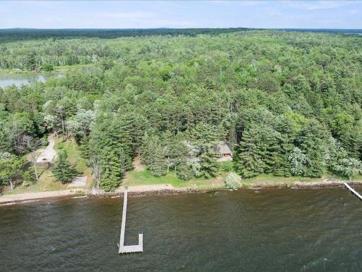 A rare opportunity to own 21.4 acres of private Whitefish Chain shoreline, where towering pines and expansive waterfront create an unmatched estate setting.