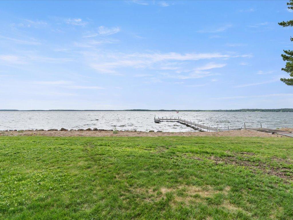Level elevation leads to 300 feet of pristine Upper Whitefish Lake shoreline, offering effortless access to the water and expansive sunset views.