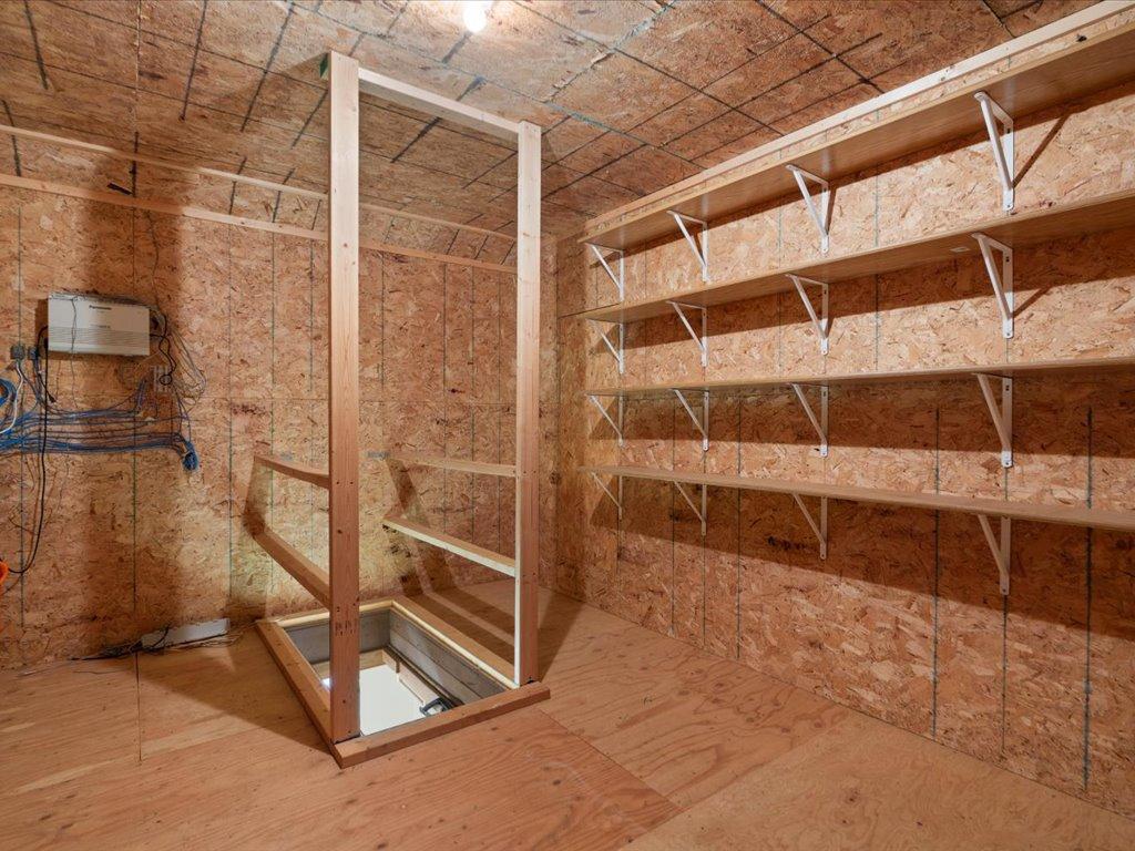 This upper-level storage room provides abundant organized storage with built-in shelving.