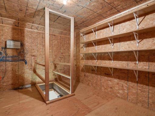 This upper-level storage room provides abundant organized storage with built-in shelving.
