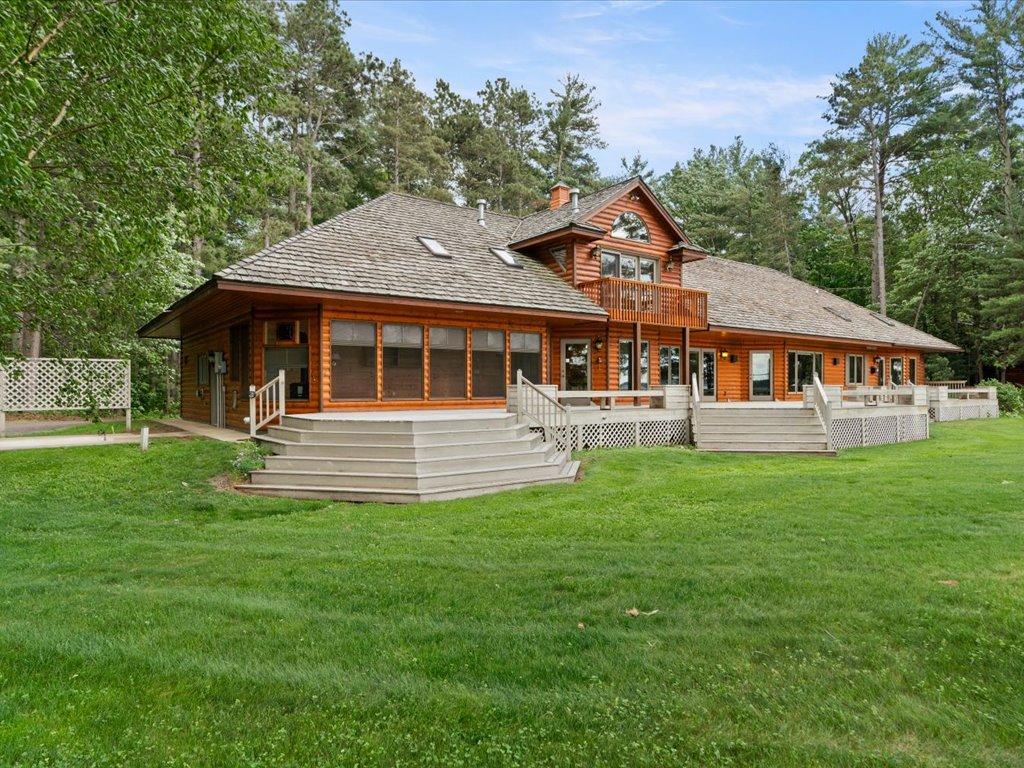 Expansive decks, a private upper-level balcony, and the vaulted three-season porch create exceptional spaces for gathering, relaxing, and enjoying the Northwoods setting.