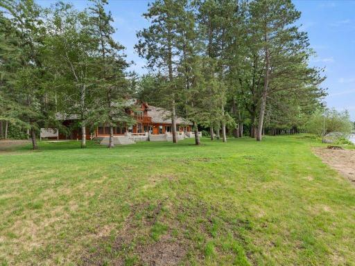 Exceptional privacy, expansive lawn space, and mature trees define this remarkable Upper Whitefish Lake setting.