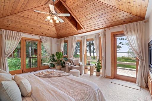 Virtually Staged. Wake up to breathtaking Upper Whitefish Lake views from the main-level primary suite, featuring vaulted wood ceilings, abundant natural light, and direct deck access.