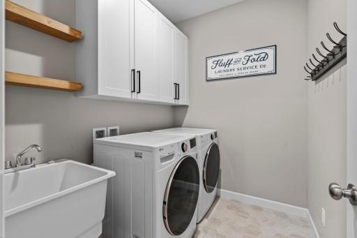 The laundry is located on the main level. Extra cabinets and shelving was added to keep you organized.