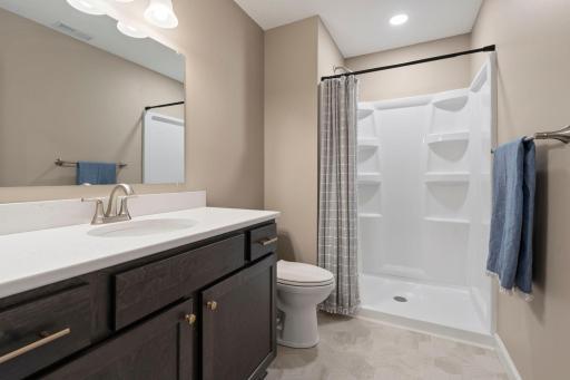 The lower level bathroom was finished to mimic the upper level style.