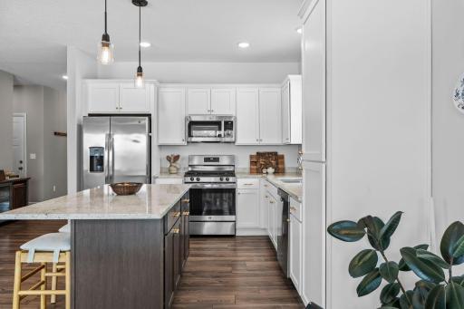 The brushed gold knobs give this kitchen a vibrant touch.