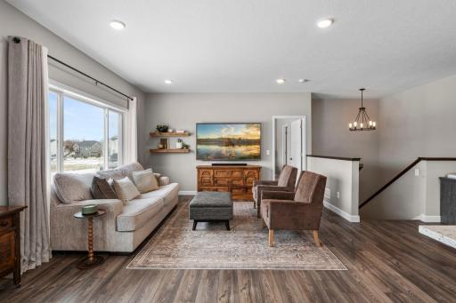 The living room features large windows for an abundance of natural light.