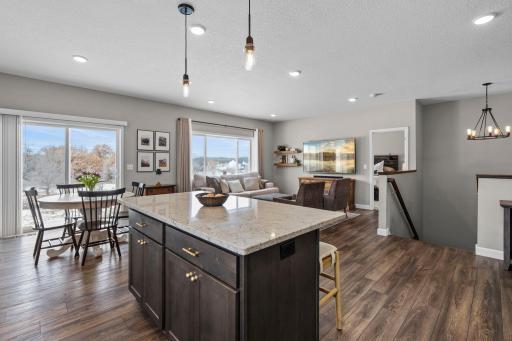 Another view of the main level area showcasing the abundance of natural light and great amount of lighting within the home as well.