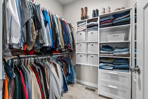The primary closet has additional shelving that can stay with the home.