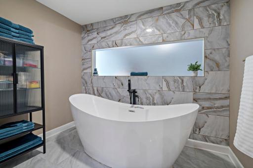 Spa-like raised soaking tub completes primary bathroom!