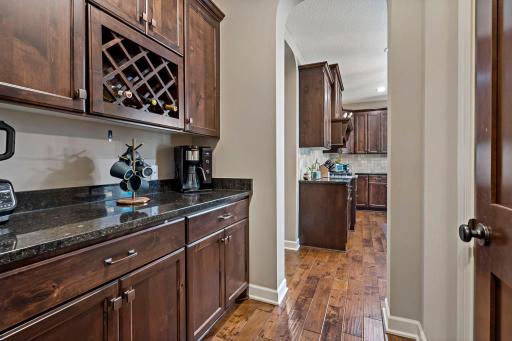 Walk-through butler's pantry with plenty of wine storage!