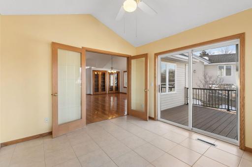 Sunroom with French doors, looking out onto the new maintenance, free deck and railing