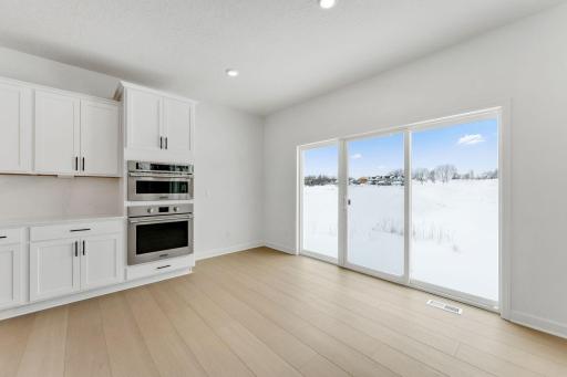 Situated in front of large glass-sliders, this dining room is washed in natural light and provides a place to serve piping-hot meals straight out of the oven.
