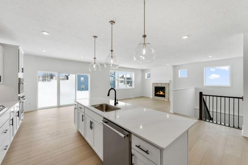 The modern kitchen comes equipped with popular features like smudge-proof appliances and designer-selected cabinetry, along with a spacious center island for bar-style meals and easy entertaining.