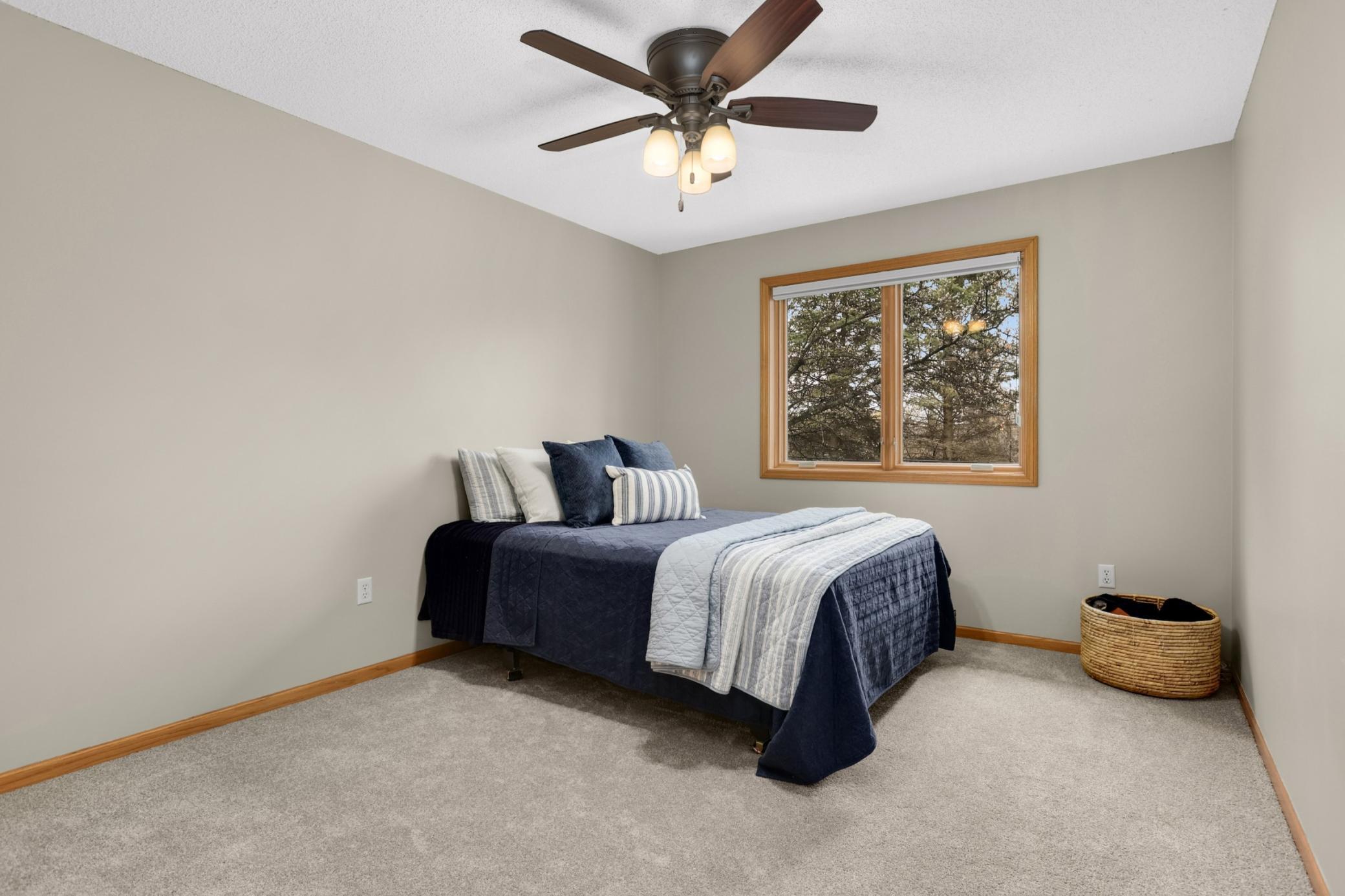 South facing bedroom with queen bed and plenty of room for additional furniture.