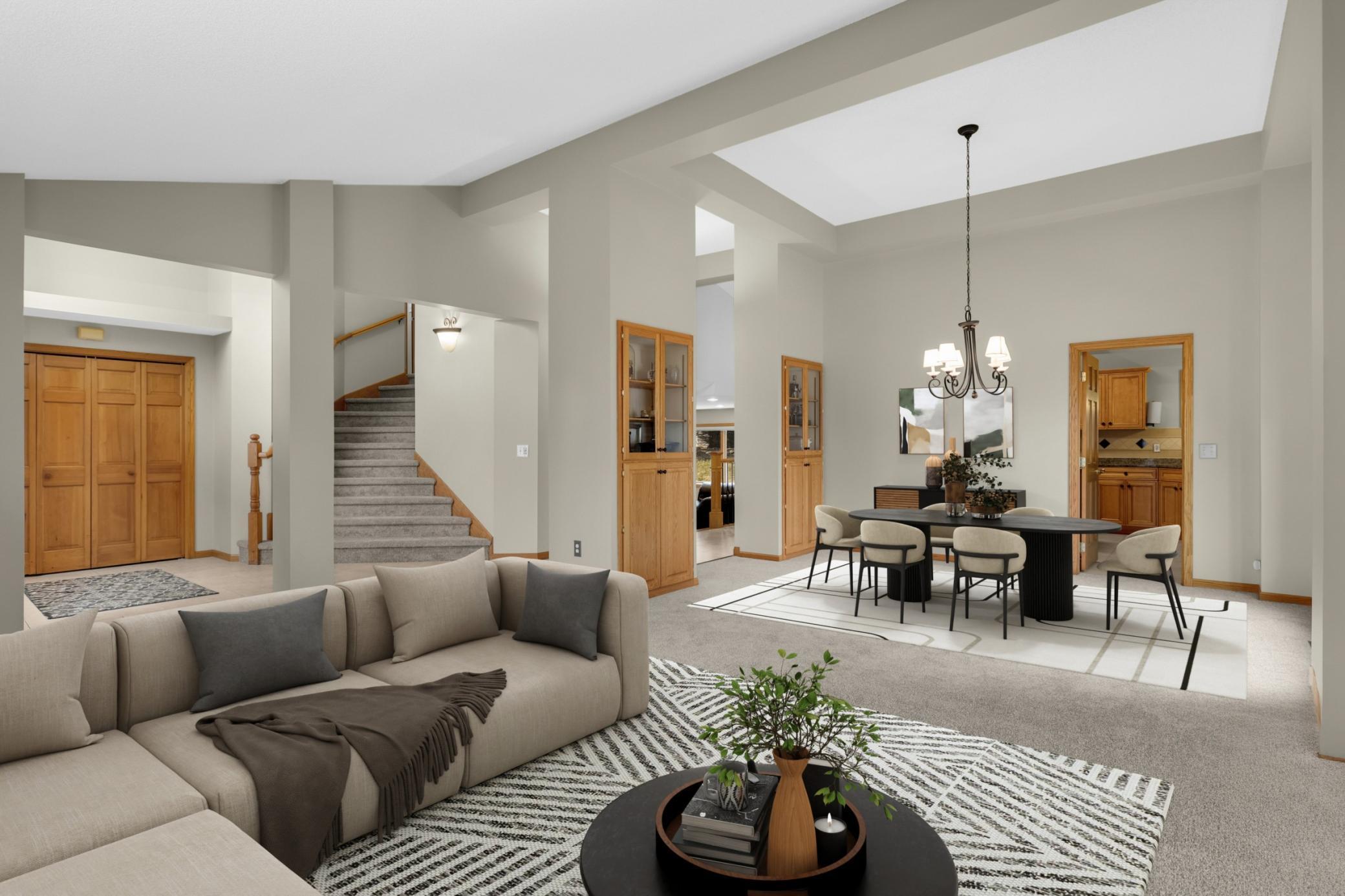 Virtually Staged. The vaulted foyer in this modified two-story welcomes guests with a flared staircase & decorative niches. The light filled living/dining rm combination are stunning & bright with abundant windows & 2026 neutral paint & new carpet.