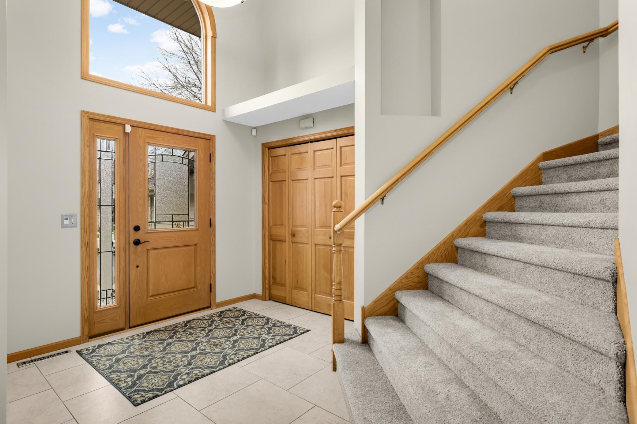 The light filled vaulted foyer is a stunning and welcoming entry that welcomes you in or provides you with easy access to the flared staircase to the upper level that has been fully carpeted in 2026.