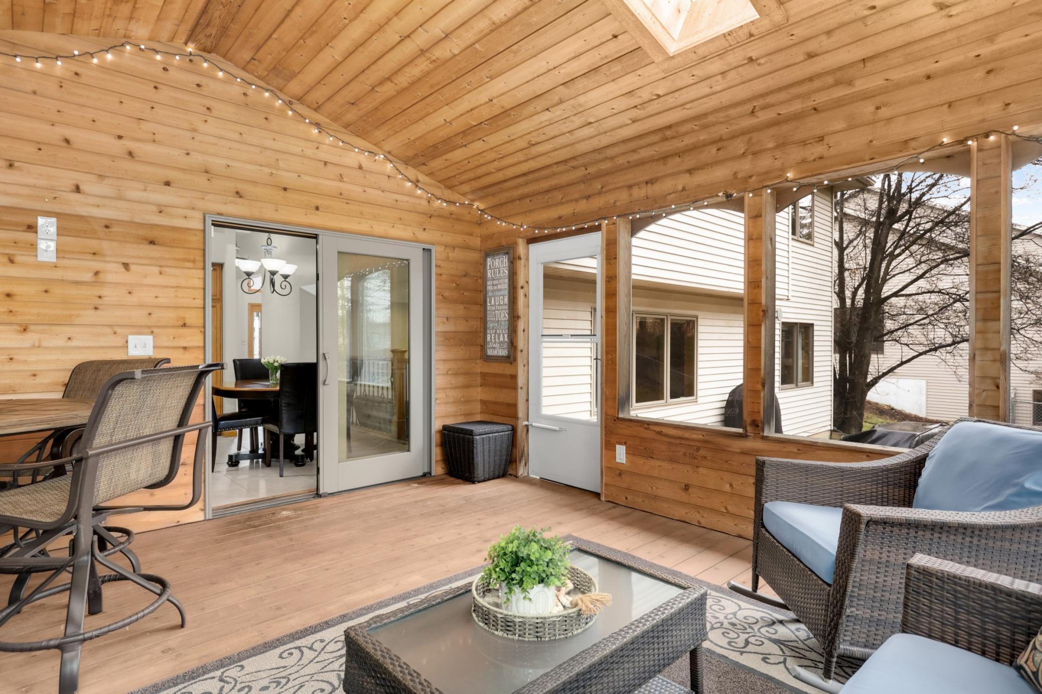 Vaulted screen porch has a ceiling fan and two sky lights and provides easy access to the backyard.