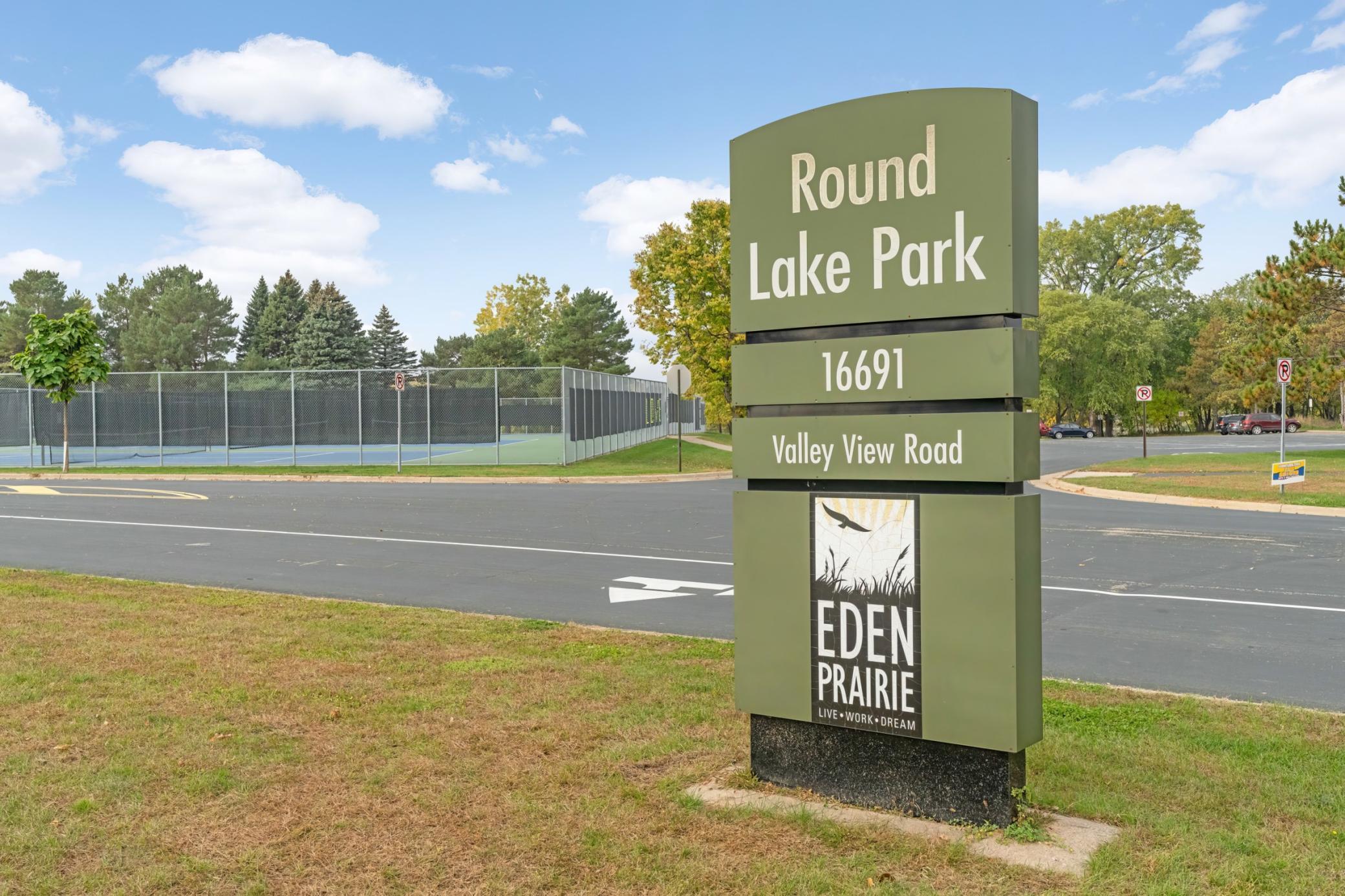 Round Lake Park is located 1 mile west & is located across from the EP Community Cntr & EPHS. It provides easy access to tennis courts, beach, park, walking trails and is the community park for Eden Priarie's 4th of July & many other annual events.