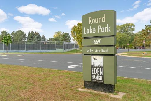 Round Lake Park is located 1 mile west & is located across from the EP Community Cntr & EPHS. It provides easy access to tennis courts, beach, park, walking trails and is the community park for Eden Priarie's 4th of July & many other annual events.
