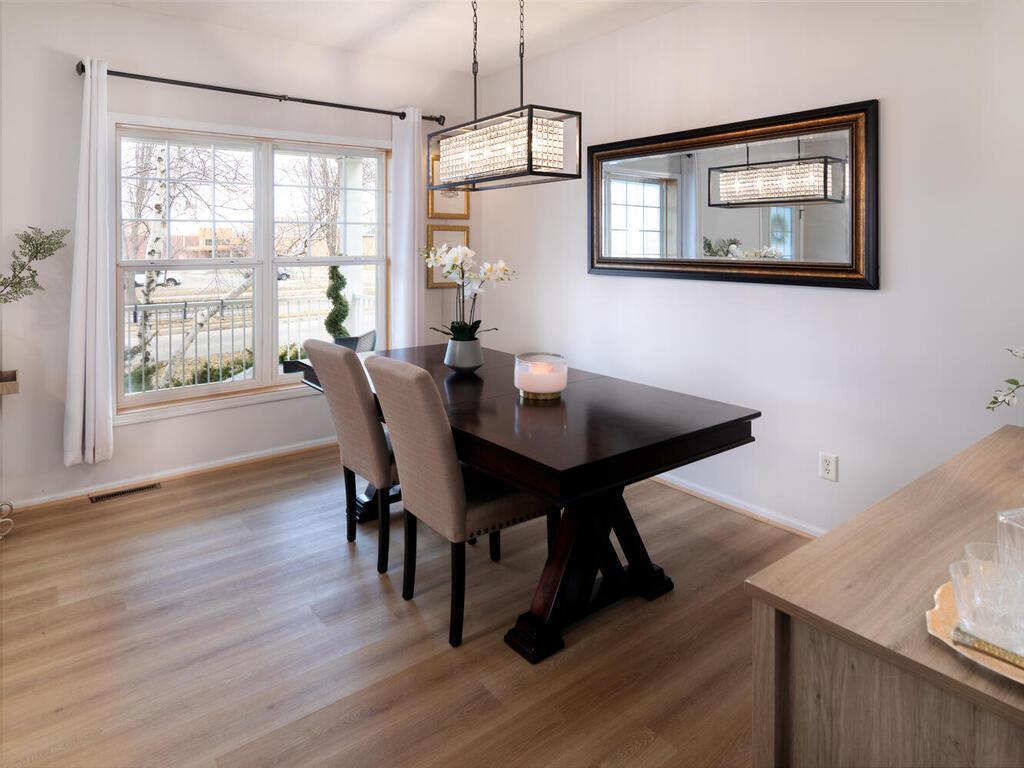 Everyone will have a space to sit, eat, and make memories in this large, bright dining room.