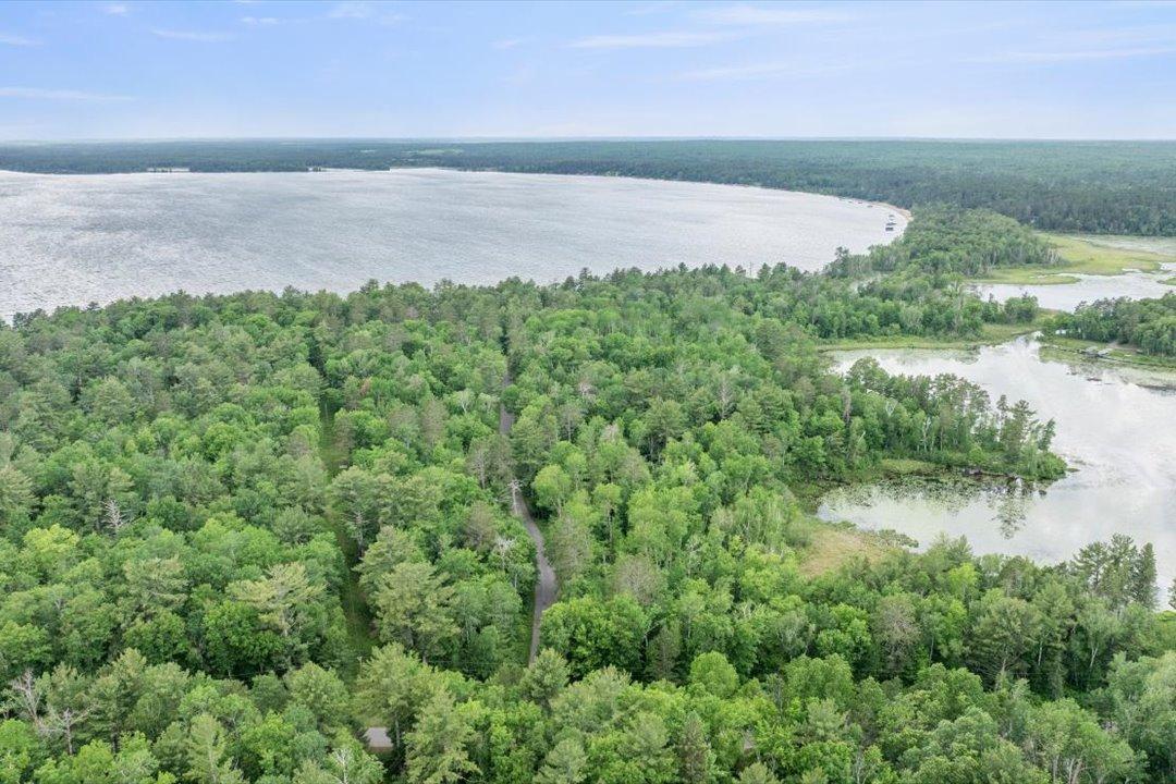 Rare 17.67-acre buildable parcel offering approximately 920' of Mud Lake frontage and water access to the renowned Whitefish Chain.
