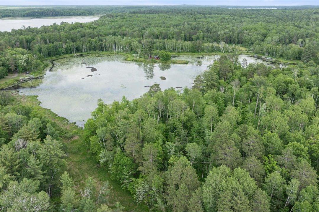 Expansive wooded acreage and approximately 920' of Mud Lake frontage offer space to create a private Northwoods retreat.