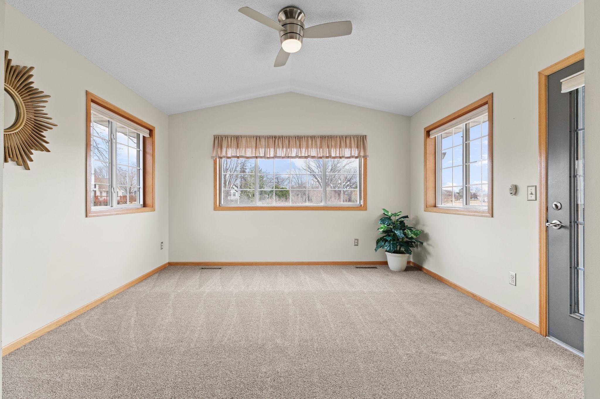 Bright and Cheery Sunroom with a patio door exiting to the semi-private rear patio with serene pond views!