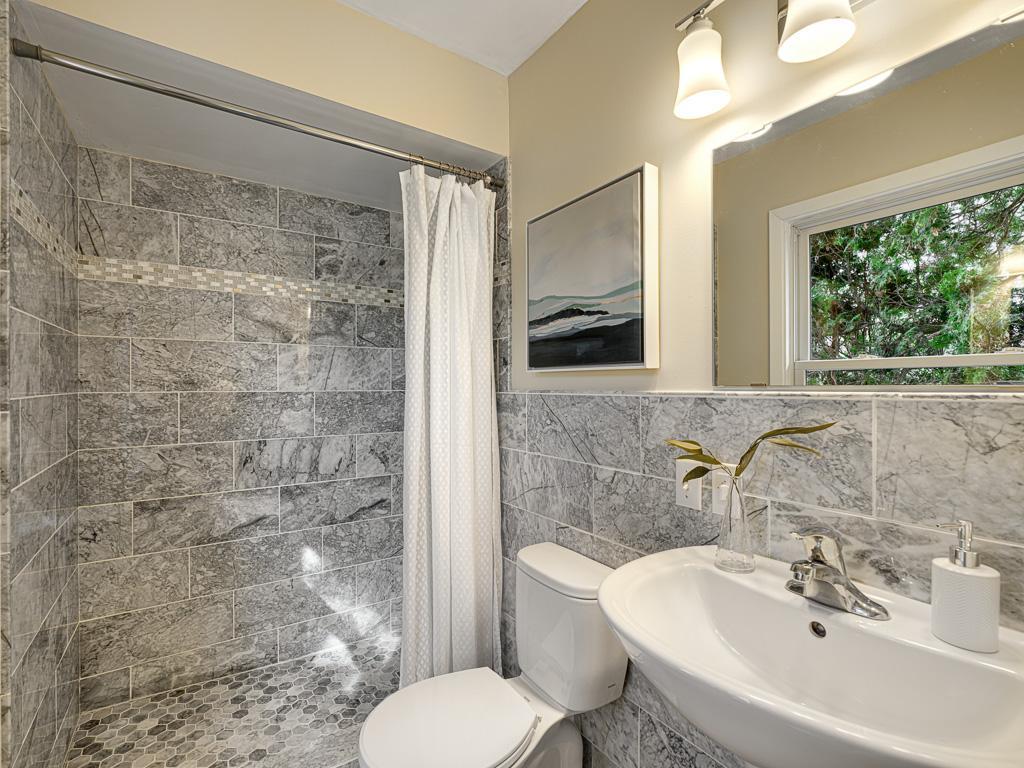 Modern tile updates in this renovated 3/4 bathroom