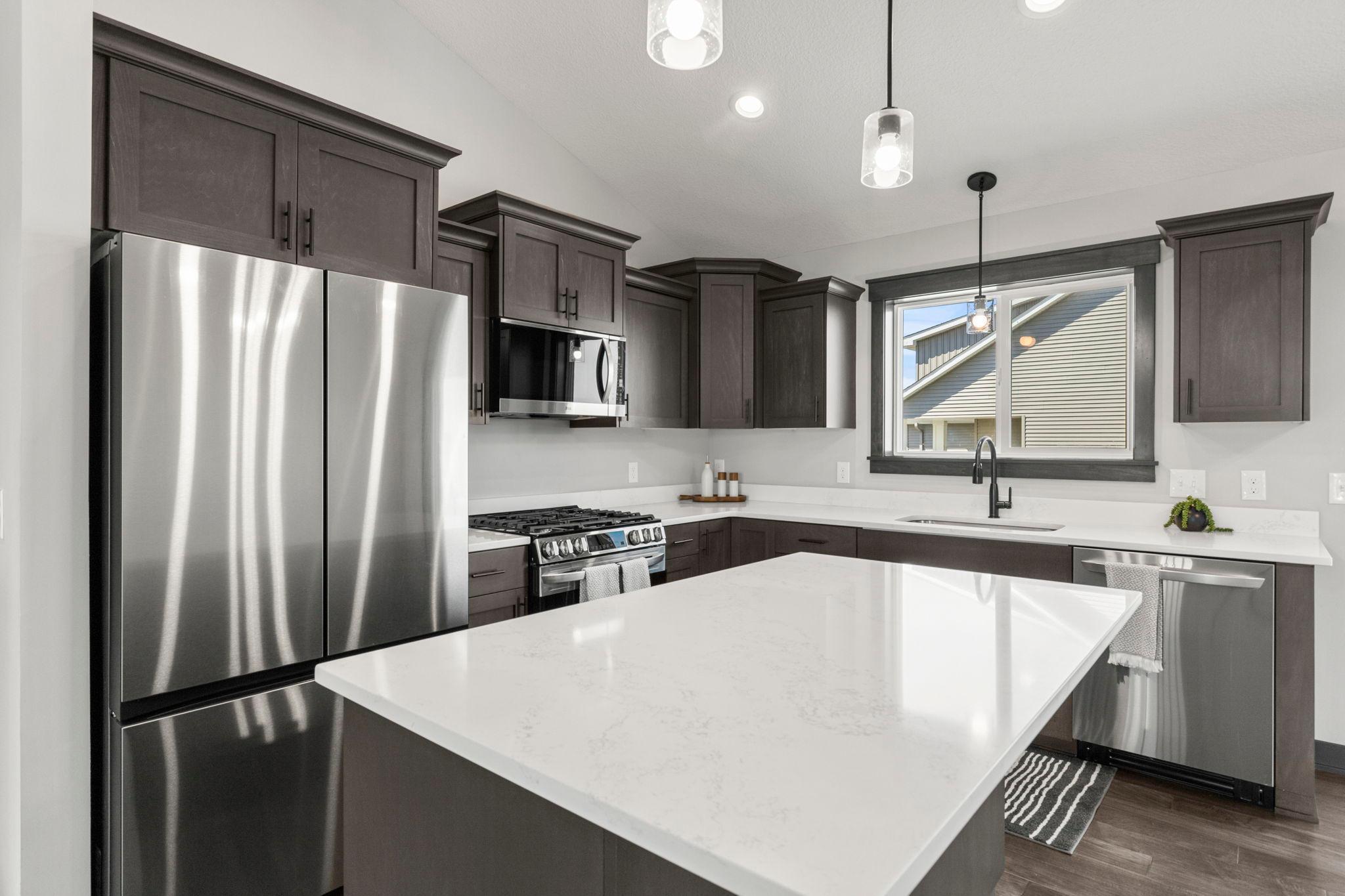 Just like new with upgraded Quartz countertop package and stainless steel already included! Gorgeous kitchen w/ modern cabinetry, fixtures and center island with breakfast bar.