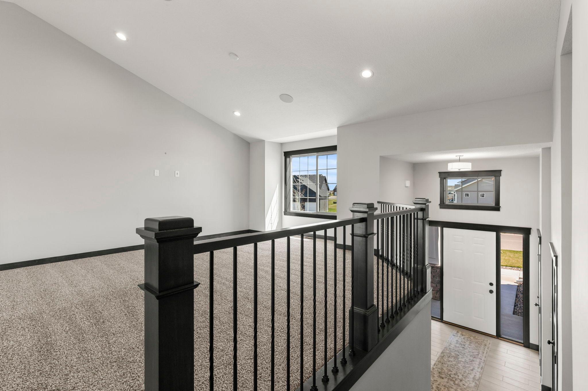 Vaulted ceilings with speakers. Warm, neutral colors throughout. Beautiful open staircase and banister sets the stage for incredible warm and inviting spaces.