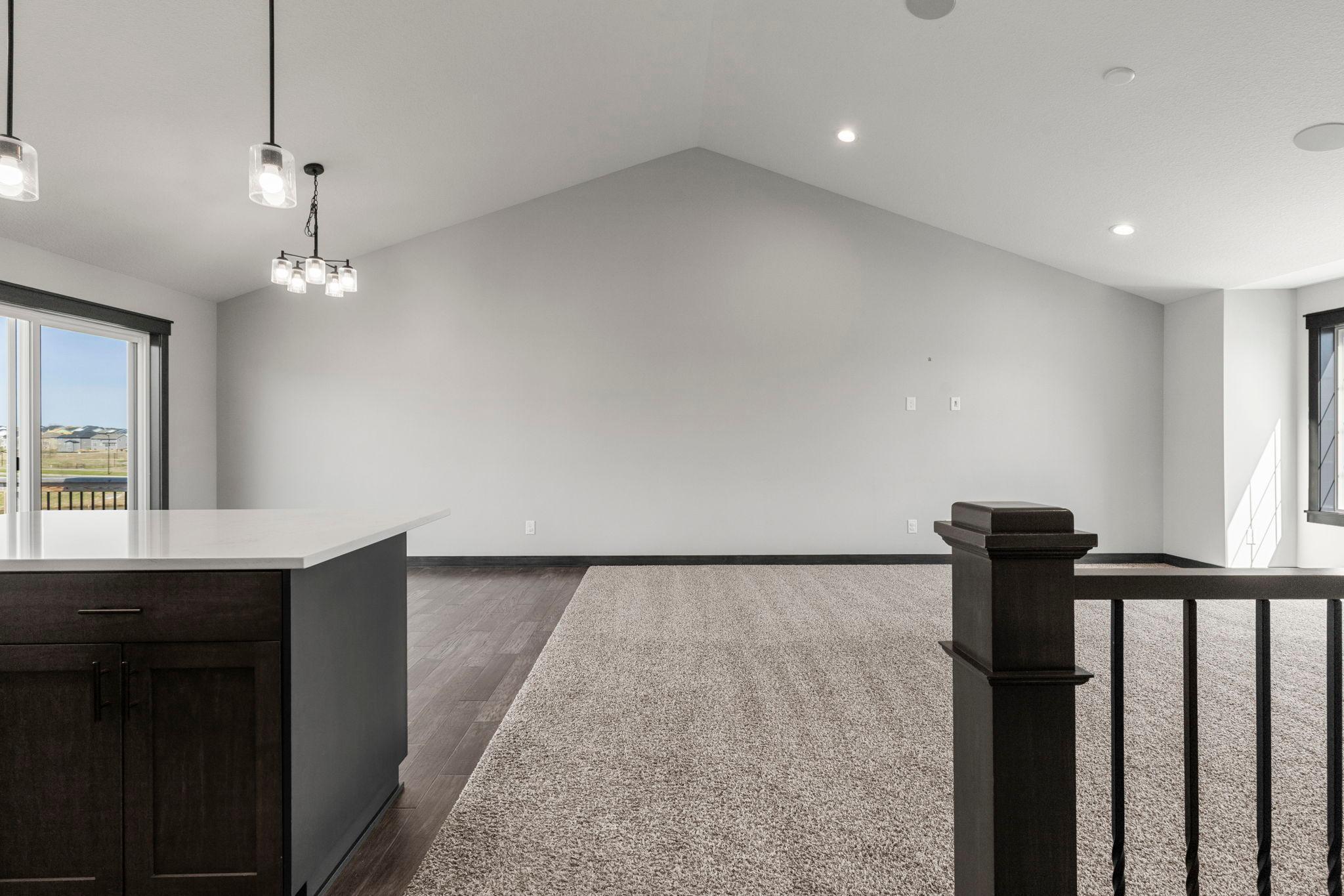 Open floor plan with vaulted ceilings. Warm, neutral colors throughout. Vaulted ceilings and built-in speaker system on main level.