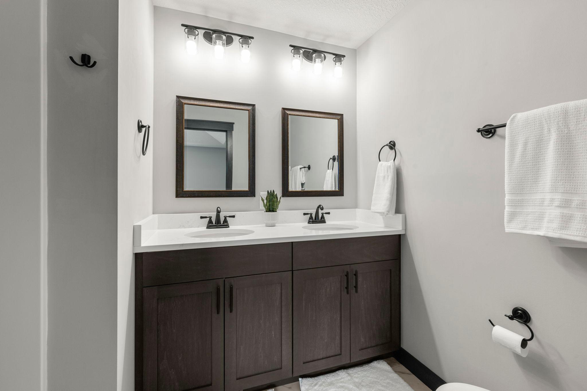 Primary bathroom, double sinks. Gorgeous tiled floors.