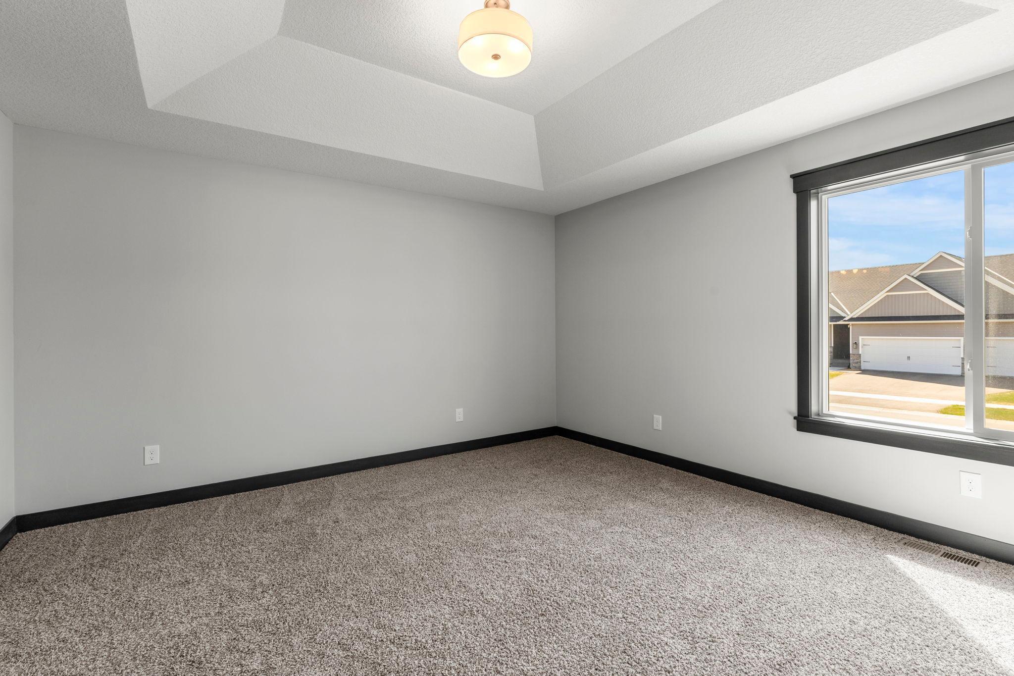 Your cozy primary retreat waits! Private luxury bathroom and walk-in closet.