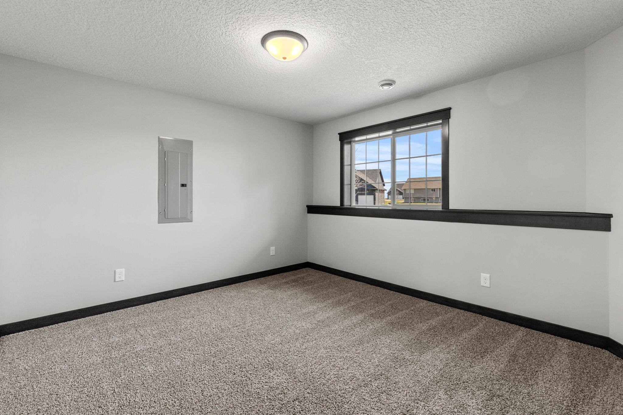 4th bedroom is a perfect office / flex space in the lower level. Looking windows bring in a ton of natural light.