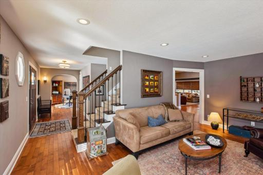 Den view of front door, foyer, stairs up and cool office area