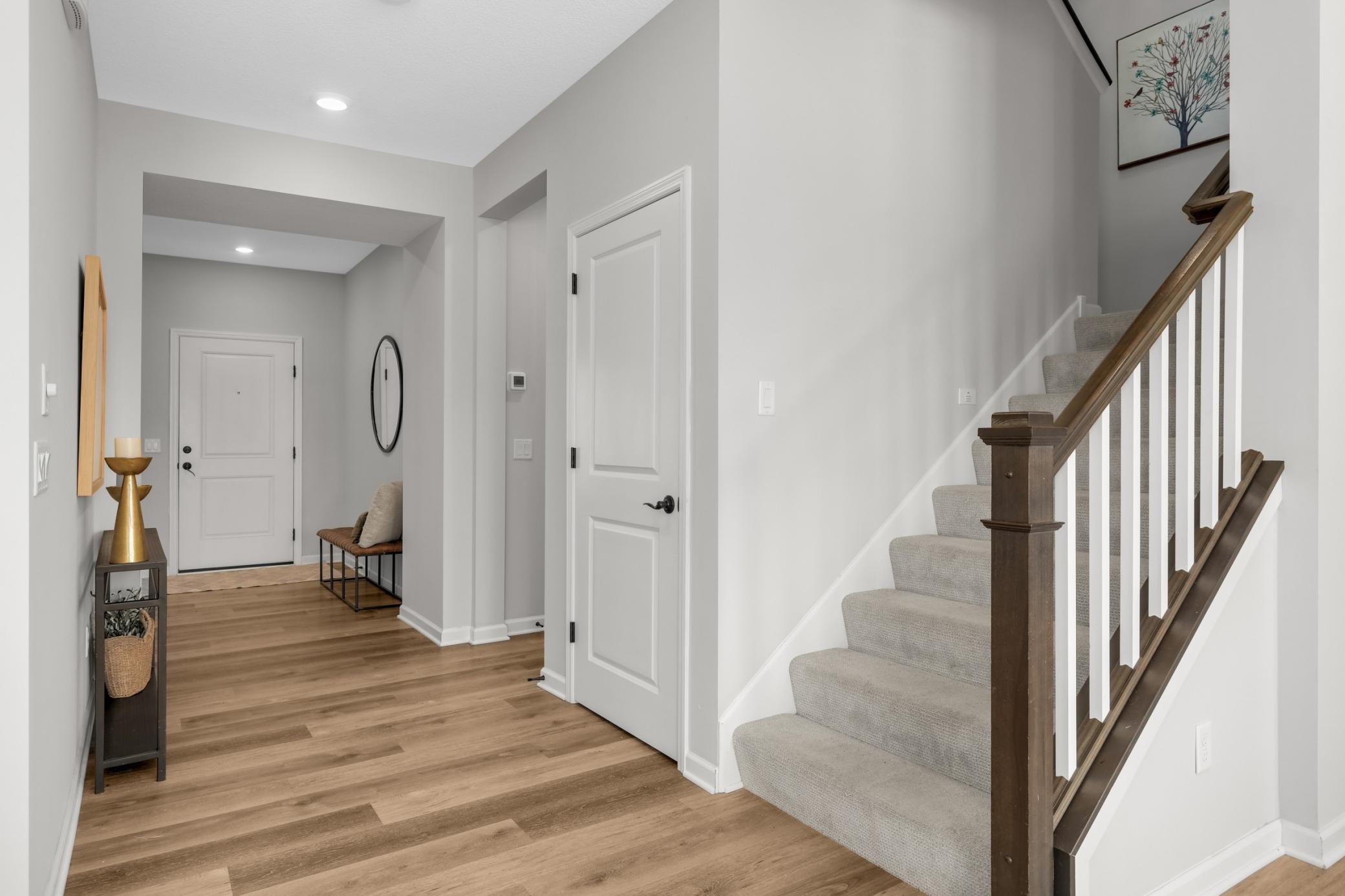 Stairwell going up and door to basement finished space.