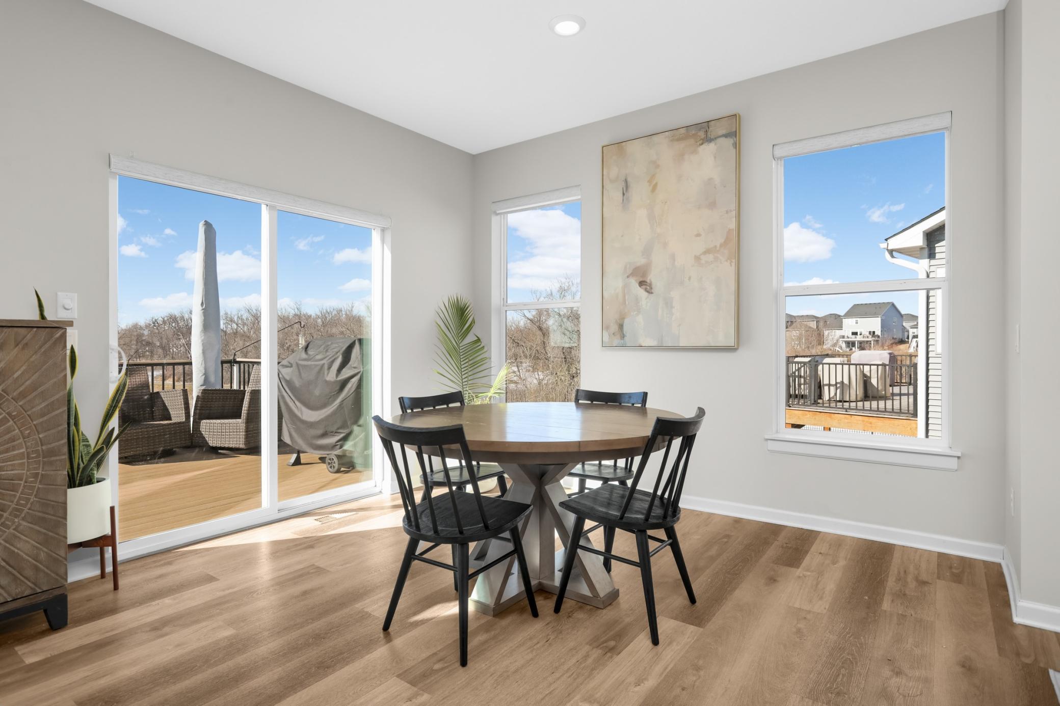 Corner dining room space with large patio door going out to the deck.