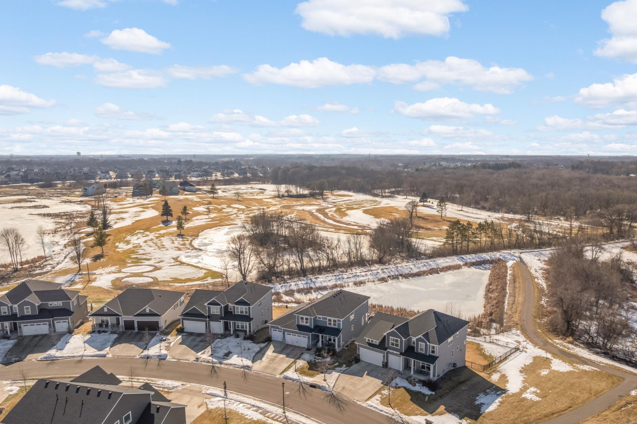 Overhead photo showing the home (second from right) backing up to the pond and golf course. No one building behind you! Other neighborhood amenities include a playground which the association maintains.