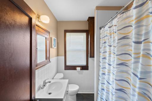 The bathroom has been updated and still has the original charm with the woodwork and medicine cabinet.