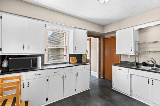 There is a good amount of kitchen cabinetry and countertops in this kitchen. The microwave oven stays with the home.