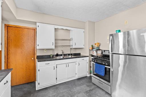The kitchen has stainless steel range, refrigerator and sink.