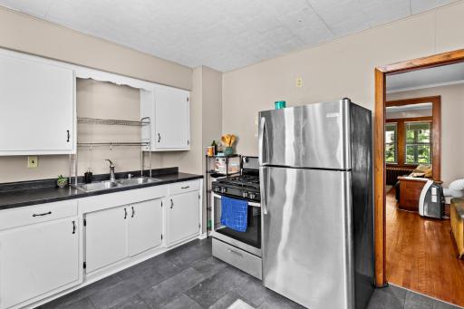The kitchen is located between the back door and the dining room. Consider that convenient for carrying groceries in.